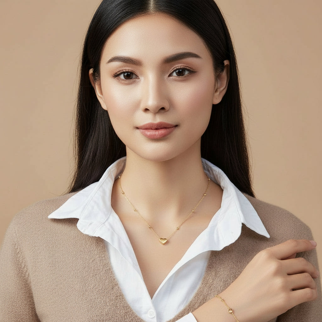 Mannequin wearing a white shirt with a gold necklace featuring a heart pendant.